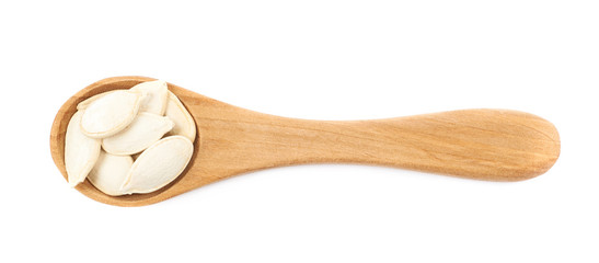 Wooden spoon full of pumpkin seeds