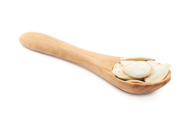 Wooden spoon full of pumpkin seeds