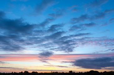 Sunset with clouds illuminated by sun.