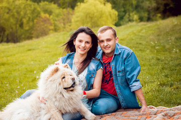 Young couple with the dogs in the park.