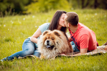 Young couple with the dogs in the park.