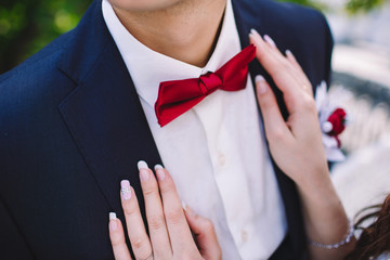 groom's bowtie closeup, hands of the bride © dron285