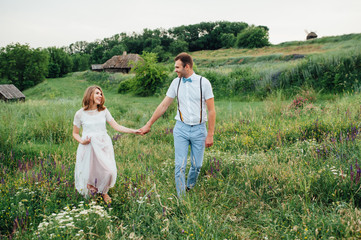 Fototapeta premium Happy Bride and groom walking on the green grass