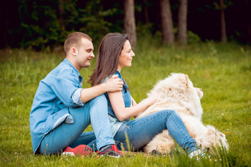 Fototapeta premium Young couple with the dogs in the park.