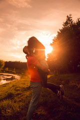 Fototapeta premium Young couple at sunset in the park.