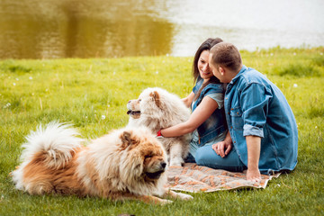 Young couple with the dogs in the park.