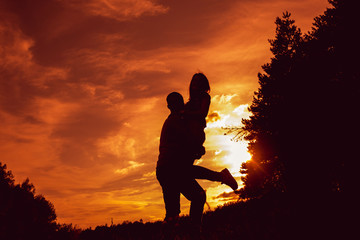 Fototapeta na wymiar Young couple at sunset in the park.