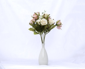Artificial roses in a vase  on white  Background.