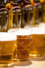 Close-up of beer glasses on the bar counter