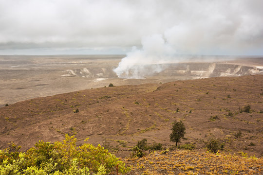 Smoking Halema uma u Crater in the Kilauea Caldera as seen from the Jaggar museum overlook.