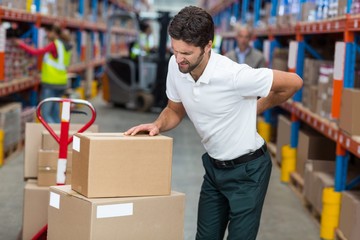 Focus of worker having a backache 