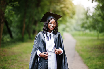 Happy beautiful black african american girl with hat and gown gr