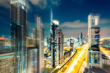 Rollo Scenic Dubai nighttime skyline with illuminated skyscrapers. Travel background. © Funny Studio