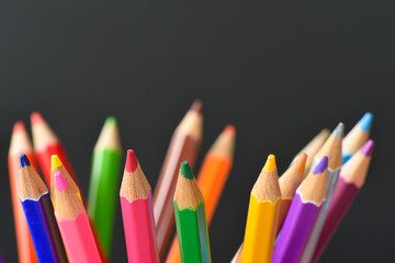 Various Colored Drawing Pencils on black background and Selective focus 