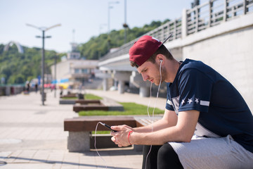 Fototapeta na wymiar man using mobile technology during outdoors exercises