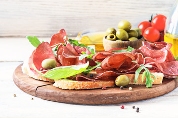 Bresaola smoked beef ham with bread and olive.