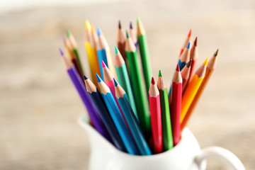 Fototapeta premium Drawing colourful pencils on a wooden background