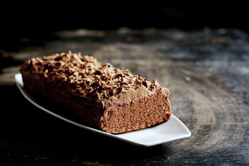 Chocolate cake on a black wooden background