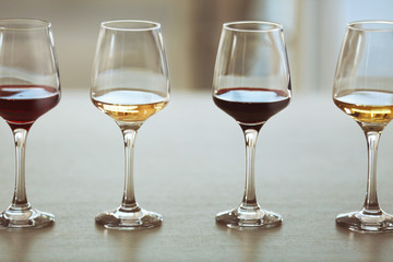 Many glasses of different wine in a row on a table