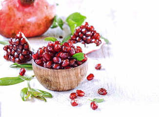 Ripe pomegranate fruit on wooden vintage background