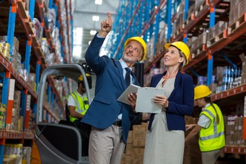 Portrait of managers are pointing and looking shelves