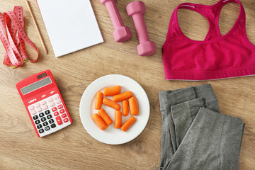 Sport equipment   healthy food   wooden background, top view