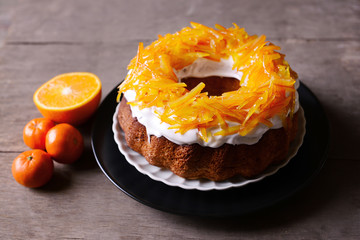 Delicious citrus cake on wooden background