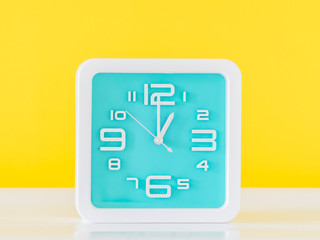 Clock and vivid yellow background.