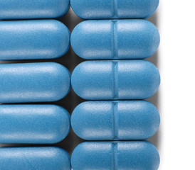 Blue pills on white background