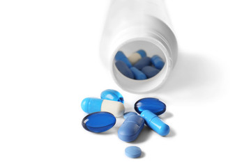 Heap of pills on white table