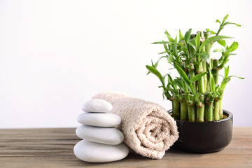 Spa composition with bamboo on light background