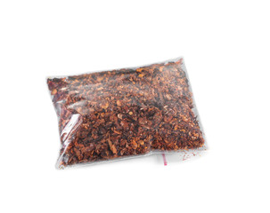 Dried chopped tomatoes in plastic zipper bag, isolated on white