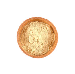 Powdered ginger in small wooden bowl isolated on white