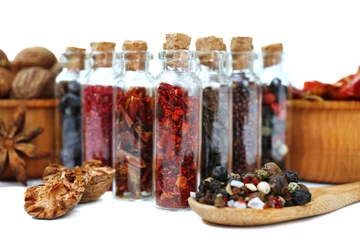 Fotobehang Assorted dry spices in glass bottles, close up © Africa Studio