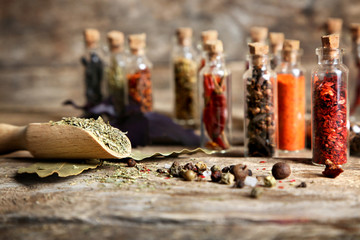Wooden scoop with spices on blurred background