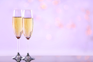 Two champagne glasses on light background