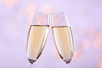Two champagne glasses on light background