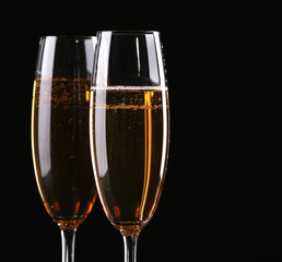 Two champagne glasses on black background