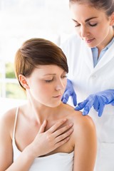 Fototapeta premium Doctor examining woman 