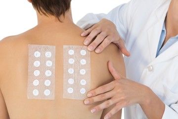 Doctor examining naked woman back