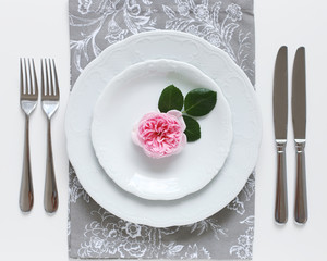 Romantic place setting with pink rose