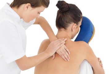 Fototapeta na wymiar Masseuse giving massage to naked woman