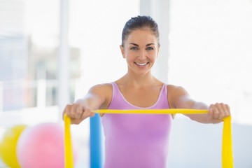 Portrait of happy woman with resistance band