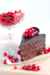 Chocolate pie with red current on white background
