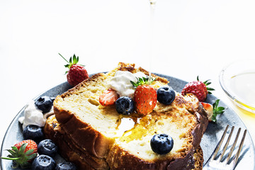 Homemade french toast sticks with honey and fresh berries. selective focus.