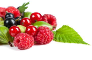 A mixture of ripe juicy fruits and berries on a white background. Raspberries, currants, gooseberries close-up. Beautiful fruit background