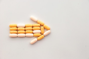 drugs pills in an arrow shape pointing at some next step or content