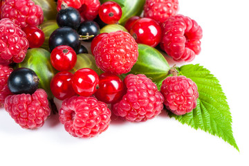 A mixture of ripe juicy fruits and berries on a white background. Raspberries, currants, gooseberries close-up. Beautiful fruit background