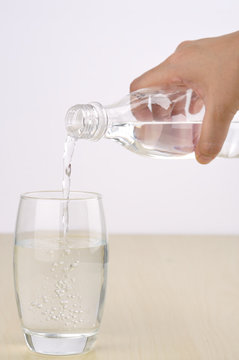 Soft Focus of Pouring Water From Bottle into Glass