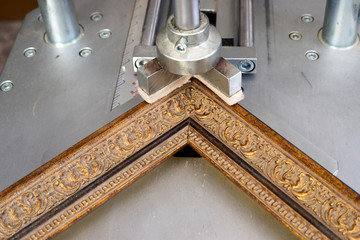 Craftsman working on frame in frameshop.
